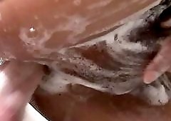 Shemale in fishnets rides a hard cock during a bath