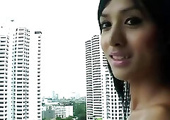 Frisky Asian t-girl oils up her tits before jacking off