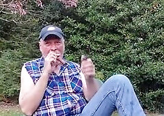 Gardener dad moving plants, then takes a break for a smoke