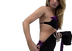 Skinny blonde tranny takes off her black dress and starts masturbating