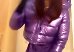 Jess Silk takes a wild ride on her dildo while dressed in a seductive purple satin outfit and a sleek purple jacket, topped off with a vibrant crimson