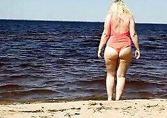 Soaked mother I'd like to fuck in a pink swimsuit, on the beach