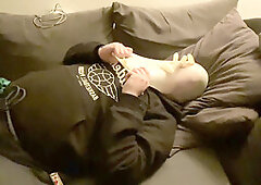 Rubber twink on the sofa getting dominated and playing with breath control