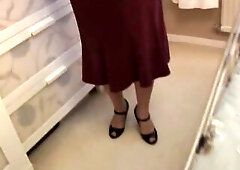 Unshaved granny in crotchless pants and nylons posing and standing over camera