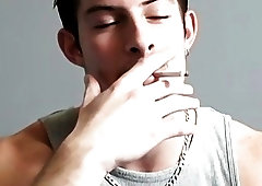 Sexy smoker wanks off big uncut cock