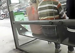 Golden-Haired was expecting for the bus, when upskirting voyeur filmed her g-string separating her slim ass cheeks.