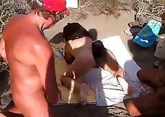 Eva Sumisa is masturbating on the beach in the middle of the day, in front of friends