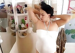 Wonderful lady in the shower room rubs cosmetic massage lotion oil on her charming legs. web camera 1-two