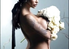 Buxom star Monika Fox poses naked with flowers behind a delicate veil